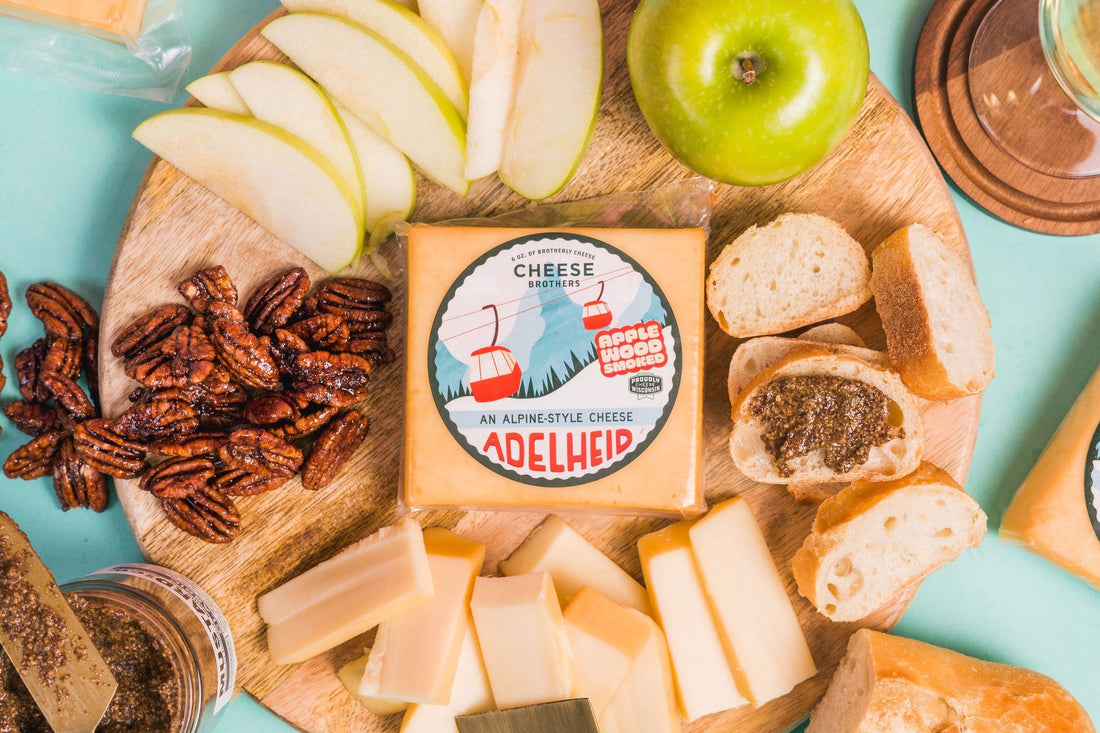 An artisan cheese board with wedges of cheese and wine, styled as a cheese gift